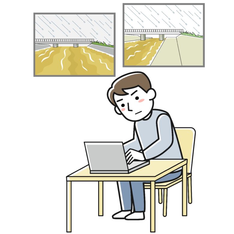 パソコンを使って河川監視カメラの映像をチェックする男性